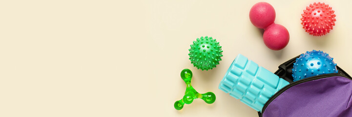 Balls,  hand massager and foam roller for myofascial release. Equipment for MFR. Tools for self-massage on pink background. Top view. Banner. Copy space