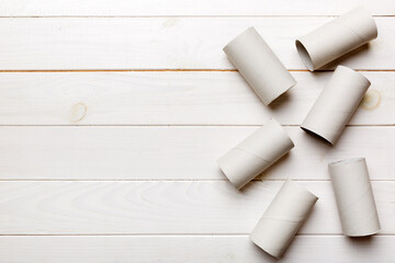 Flat lay composition with empty toilet paper rolls and space for text on color background. Recyclable paper tube with metal plug end made of kraft paper or cardboard