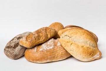 Homemade natural breads. Different kinds of fresh bread as background, perspective view with copy space