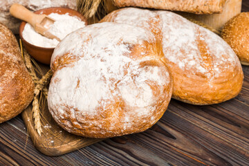 Homemade natural breads. Different kinds of fresh bread as background, perspective view with copy space