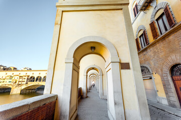 Morning view on beautiful arcade near famous Ponte Vecchio on Arno river in Florence, Italy. Concept of italian renaissance architecture