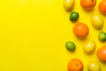 Fruit background. Colorful fresh fruits on colored table. Orange, lemon, grapefruit Space for text healthy concept. Flat lay, top view, copy space