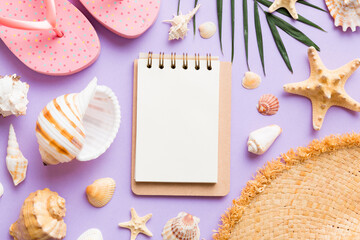 Blank writing book with summer beach accessories on background, copy space. Flat lay with copy space
