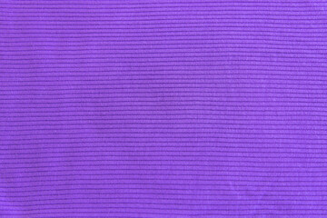 Fototapeta premium Very peri show texture of ribbed cotton fabric. Close up. Cotton clothing and textiles. Natural organic fabrics texture purple, violet colour