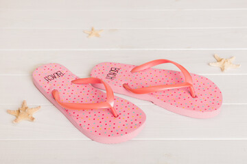 Beach accessories. Flip flops and starfish on colored background. Top view Mock up with copy space
