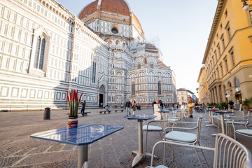 Morning view on cafe terrace on cathedral square near famous Duomo cathedral in Florence. Traveling famous places in Italy concept