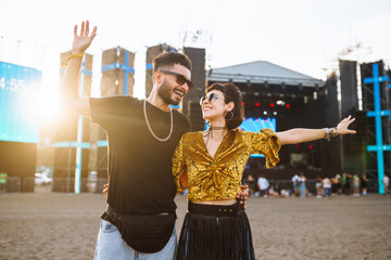 Lovely couple having fun at festival.  Young friends with beer at beach party. Summer holiday,...