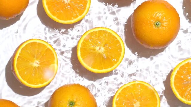 Oranges with water ripple effect. Mandarin with water splash on white background.