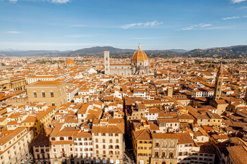 Fototapeta na wymiar Aerial view on the old town of Florence with famous Duomo cathedral on skyline on sunny day. Outstanding cityscape of tuscany. View from Vecchio palace