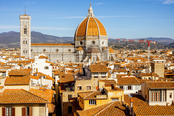 Fototapeta na wymiar Aerial view on the old town of Florence with famous Santa Maria del Fiore cathedral on skyline on sunny day. Outstanding cityscape of tuscany. View from Vecchio palace