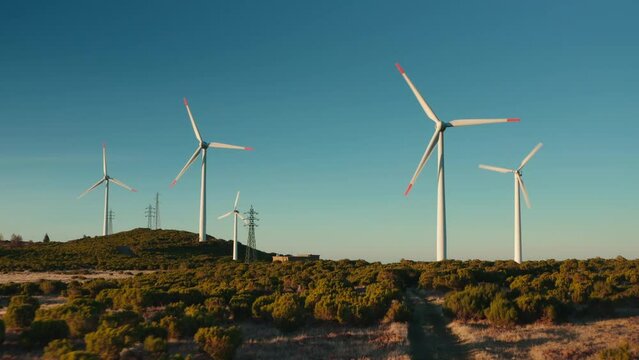 rotation wind turbine wind mills on the hill blue sky background green energy packshot