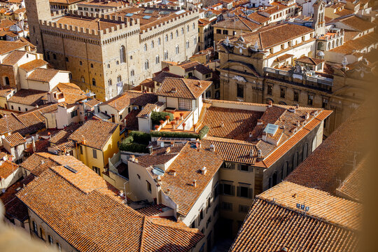 Fototapeta Aerial view on the beautiful rooftops of ancient houses and streets in Florence on sunny day