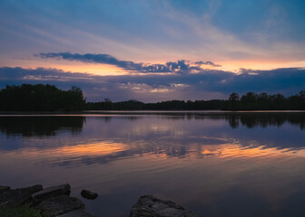 Sunset reflected in the peaceful waters of Ross Lake, Beaverton, Michigan.