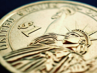 Fragment of American 1 dollar coin closeup. Statue of Liberty and the sign of national currency. US...
