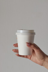coffee cup in hand, mockup, custom design, close-up