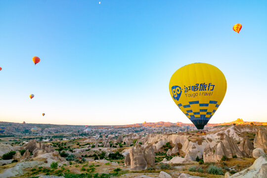 A yellow hot air balloon on the sky of Cappadocia in Turkey
