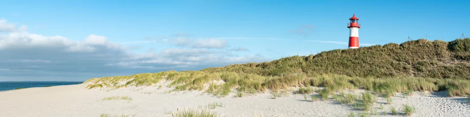 Foto op Canvas Panoramic view of a lighthouse standing near the coast of Sylt, North Sea, Germany  © eyetronic