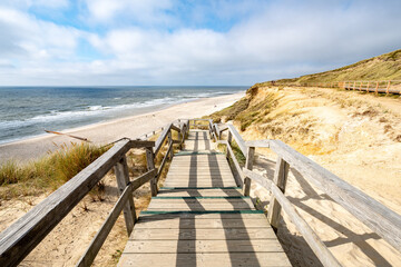 Wooden stairs leading to the beach near the Rotes Kliff (red cliff), Kampen, Sylt, Schleswig-Holstein - obrazy, fototapety, plakaty