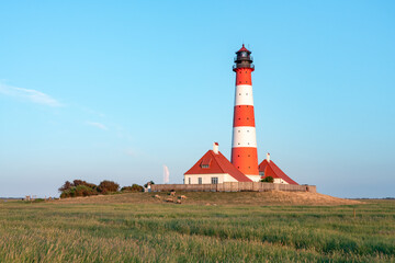 Fototapeta na wymiar Red tower of the Westerheversand Lighthouse, Westerhever, Schleswig-Holstein, Germany