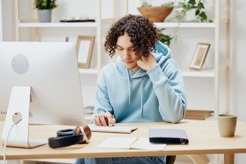 portrait of a man sitting in front of the computer work at home technologies