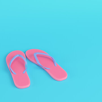 Pink flip flops on bright blue background in pastel colors