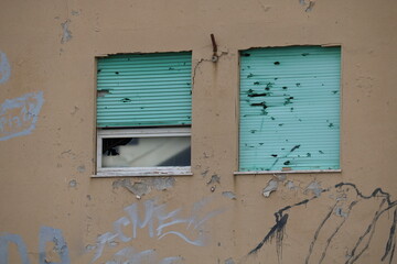 Broken Window and Roller Shutter of old House 