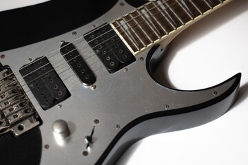 Fototapeta na wymiar Close-up of electric guitar in black and gray