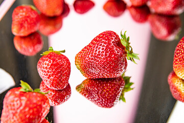 fresh appetizing strawberries on a pink background