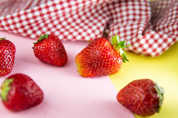 fresh appetizing strawberries on a pink background