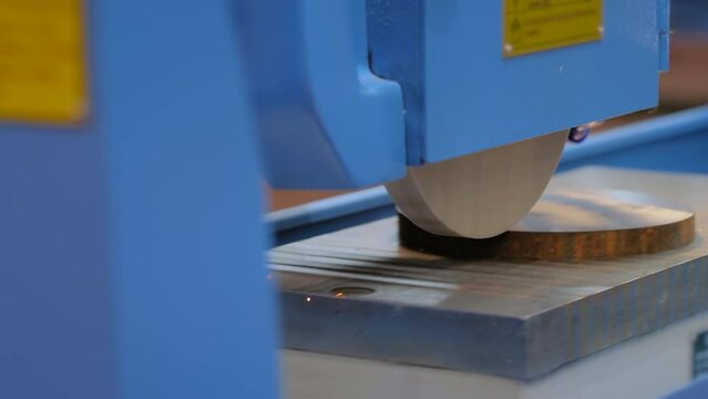Surface grinding wheel machine working with piece of metal with sparks at factory, plant. Metalworking, machining, industrial, equipment, technology and manufacturing concept