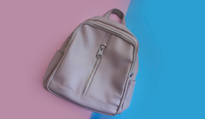Empty light backpack on a colored background