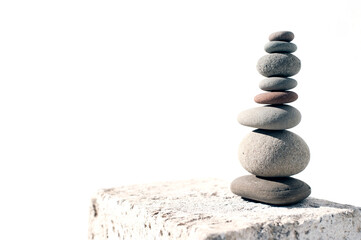 Organic beach stone tower on a white background.