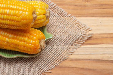 Brazilian party corn in a bowl on a straw background