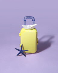Minimal travel composition. Suitcase on pastel light purple background. Creative summer holiday concept.