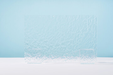 Acrylic ribbed plate, background for cosmetic product packaging on blue backdrop. Showcase for...