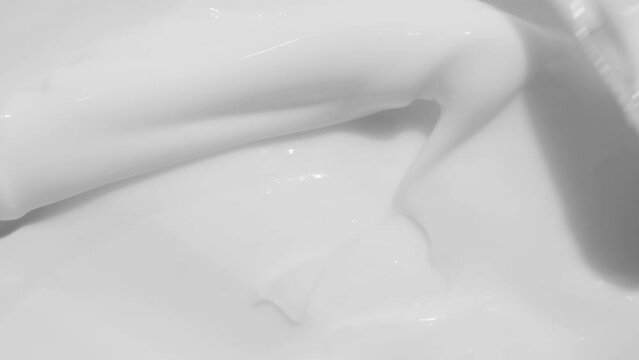 Moisturising creme swatch motion with spatula. Skin care light creamy cosmetic beauty product smudge closeup video. White cream texture footage. Skincare cosmetics sunscreen lotion mousse close up