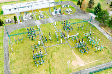 Top view of electrical substation among fields, aerial view of high voltage tower