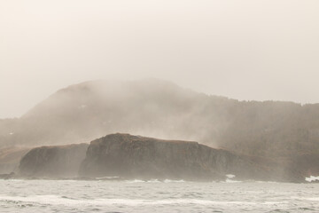 A storm moves in on the ocean of newfoundland, heavy mist and rain