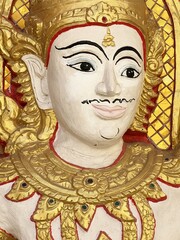 white angle statue on gold wall