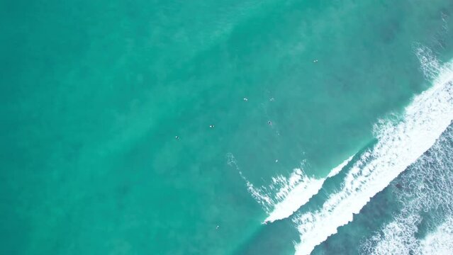Amazing aerial view Top down of waves break on tropical sea Surfers with surfing boards Aerial drone view 4-k shot of sea waves on the beautiful ocean at Phuket Thailand