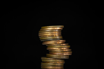 Stack of coins about to fall over