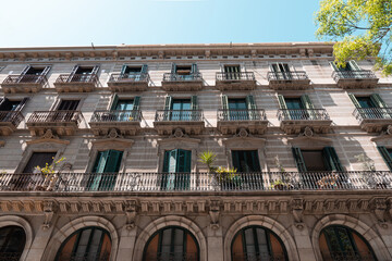 Classic apartment building with balconies and shutters in Barcelona