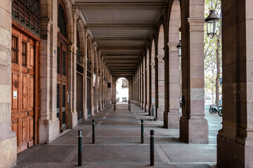 Hallway with geometric columns and diminishing perspective. Walkway arch style
