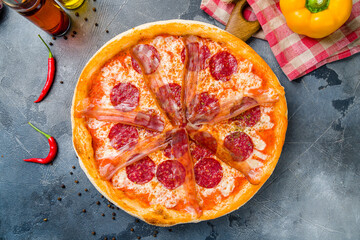 Pepperoni pizza with parma ham on grey table top view