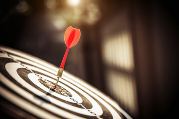 Bullseye or Bulls eye target or dartboard has dart arrow throw hitting the center of a shooting for...