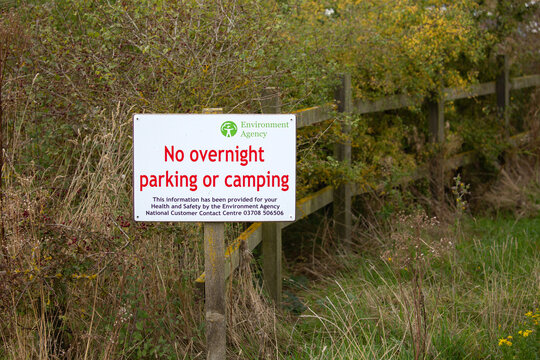 No Overnight Parking Or Camping Sign Attached To Fence From The Environmental Agency In Norfolk, UK