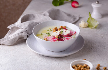 Cauliflower soup puree decorated with radish