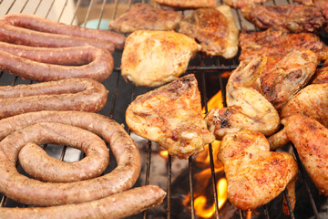 Braaied meat on the grill. South African braai with chicken, chops, boerewors lamb chops