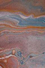 Abstract fluid art in acrylic paint in rusty earthy colours