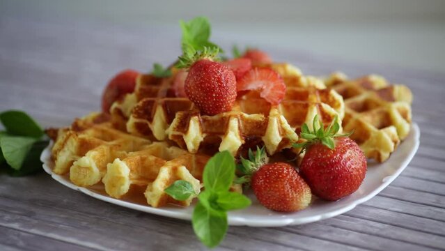 Sweet curd cooked waffles with fresh ripe strawberries